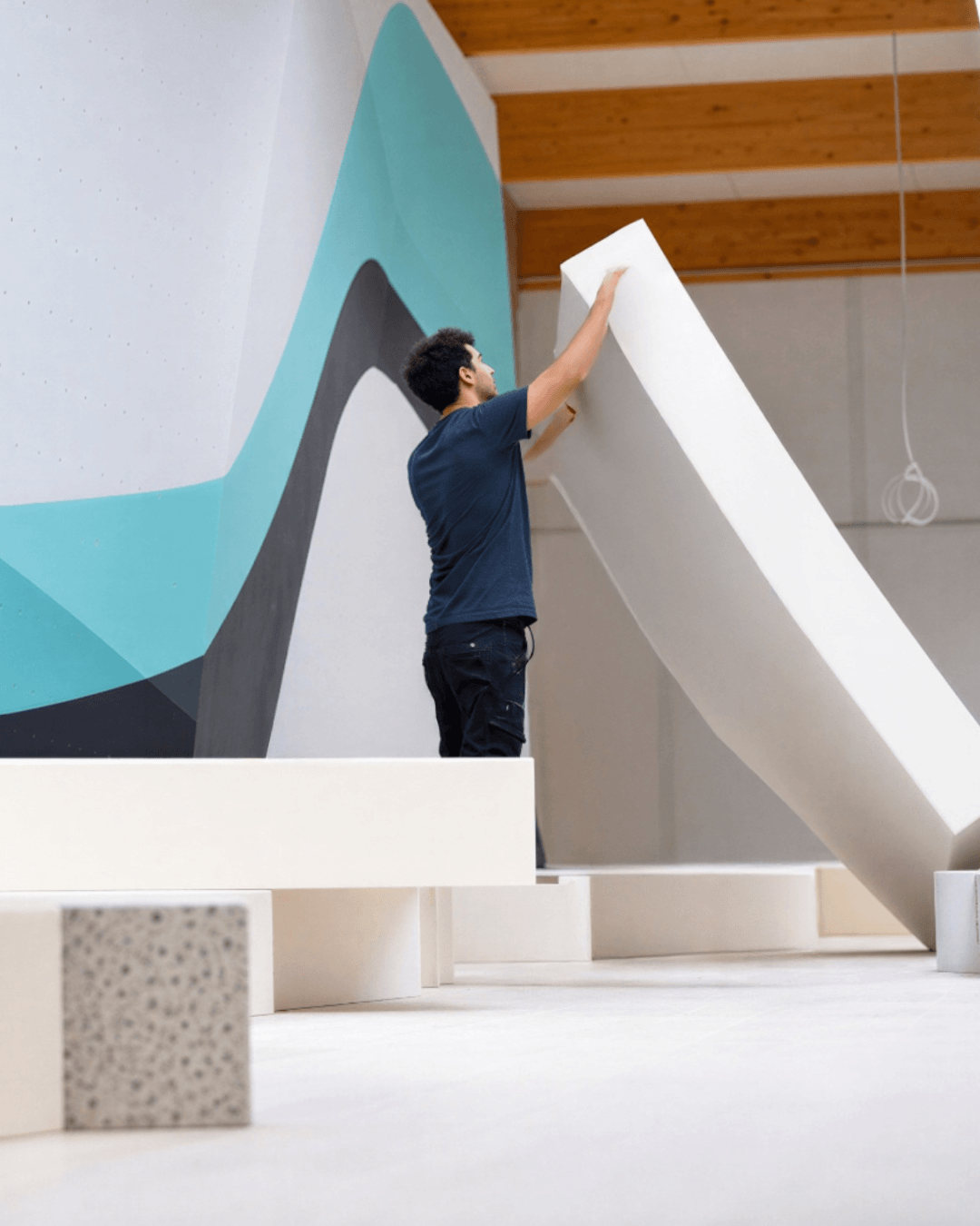 Custom fall protection matting system installed under a bouldering wall.